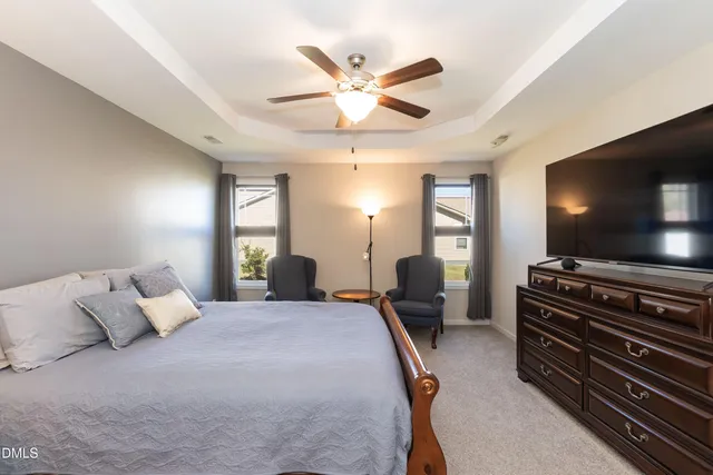 a bedroom with furniture and a flat screen tv