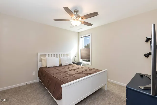 a living room with furniture and ceiling fan