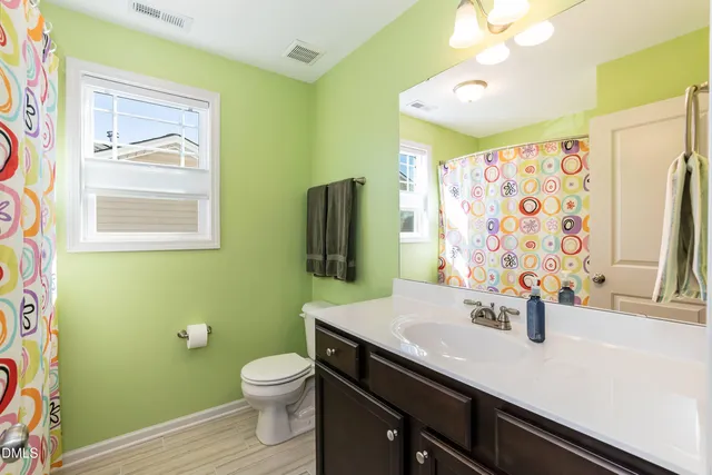 a bathroom with a sink a toilet and mirror