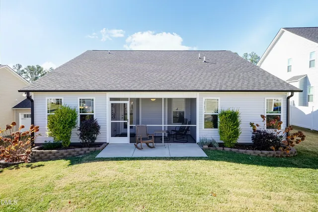 a front view of house with yard and outdoor seating