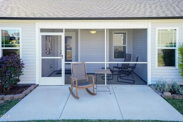 a view of a patio with table and chairs and potted plants