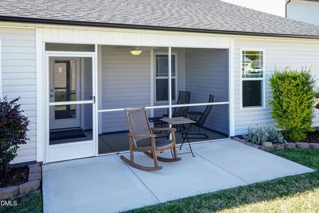 a view of a patio with table and chairs and potted plants