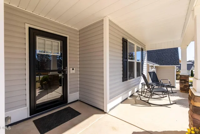 a view of dining room with a table and chairs and barbeque grill with granite countertop