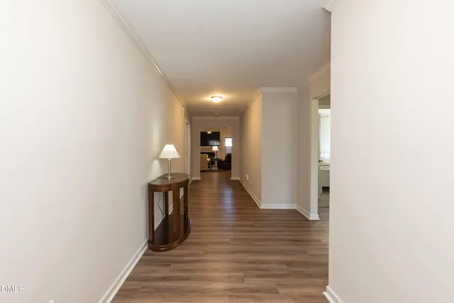 a view of a hallway with wooden floor
