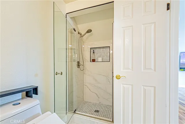 a view of a hallway with entryway and stairs