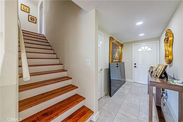 a view of a hallway with wooden floor and cabinet
