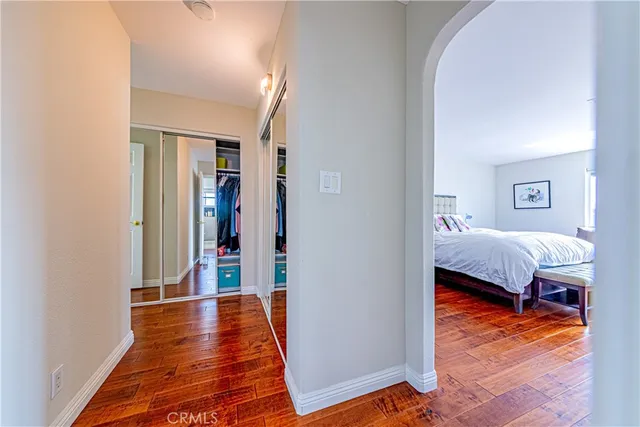 a bedroom with furniture and a wooden floor