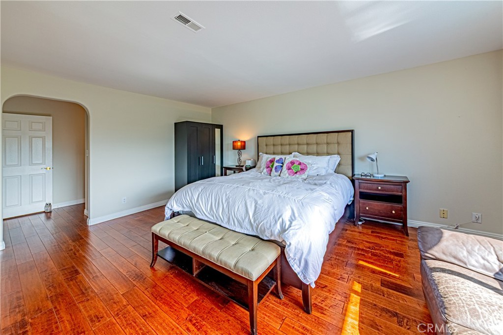 774 Stephens Avenue Fullerton, CA 92833 - Photo 19 of 53 a bedroom with a bed a dresser and wooden floor