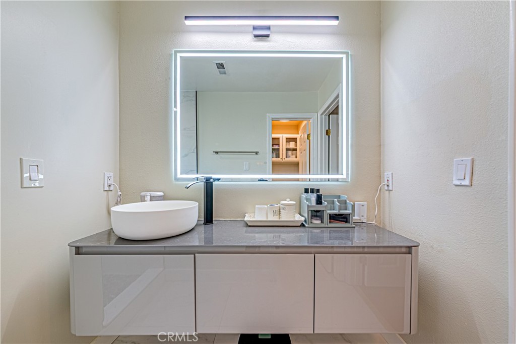 774 Stephens Avenue Fullerton, CA 92833 - Photo 24 of 53 a bathroom with a granite countertop sink and a mirror