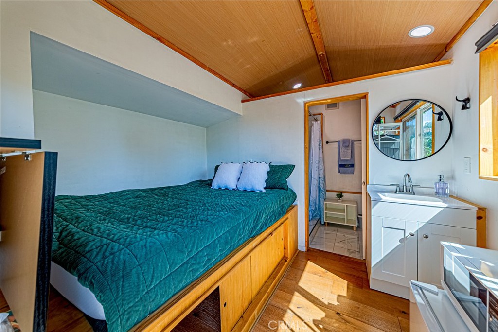 774 Stephens Avenue Fullerton, CA 92833 - Photo 43 of 53 a spacious bedroom with a bed and a chandelier