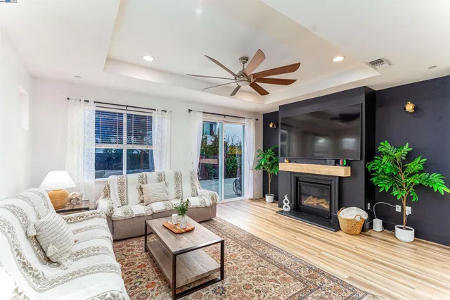 a living room with furniture a window and a fireplace