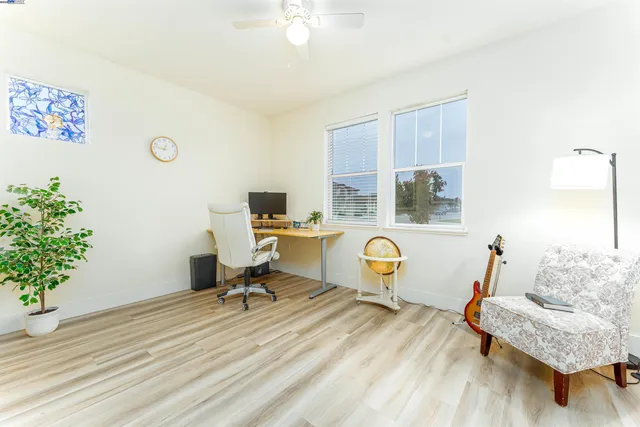 a view of a workspace with furniture and a potted plant
