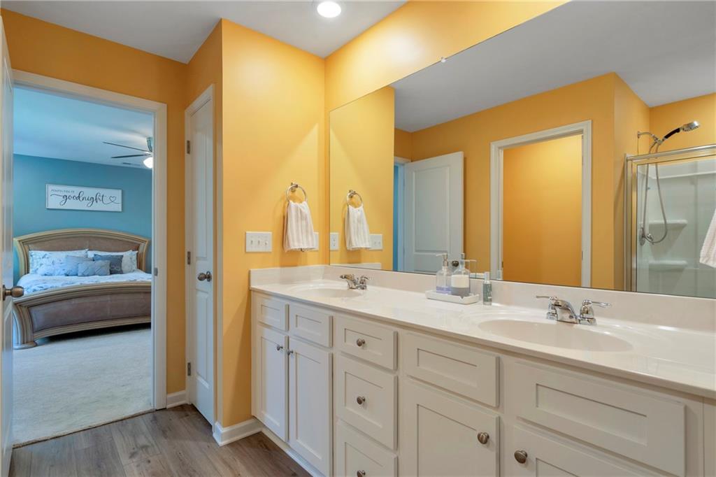 660 Groover Street Ball Ground, GA 30107 - Photo 28 of 53 a en suite bathroom with a double vanity sink and mirror