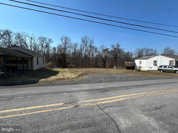a view of a parking area and a car parked on road