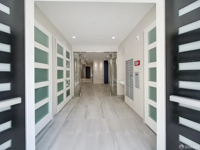 a view of walk in closet with wooden floor