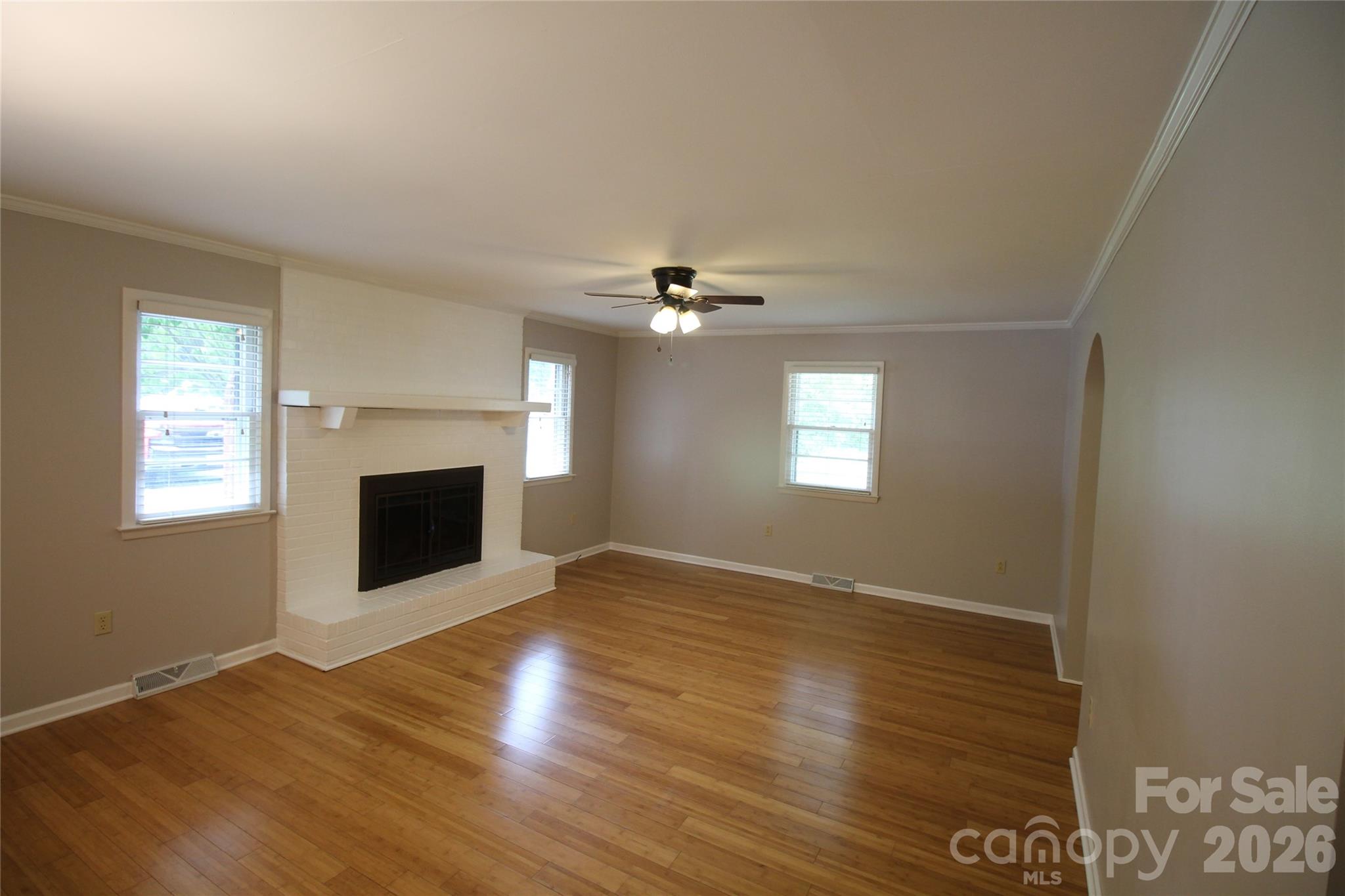 203 Ratchford Farm Road Gastonia, NC 28056 - Photo 10 of 38 a view of an empty room with wooden floor fireplace and a window