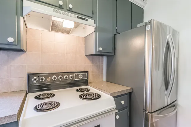 a kitchen with a stove and a refrigerator