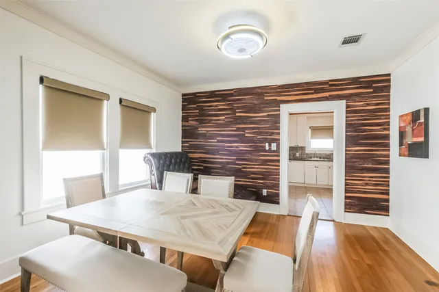 a dining room with furniture and wooden floor