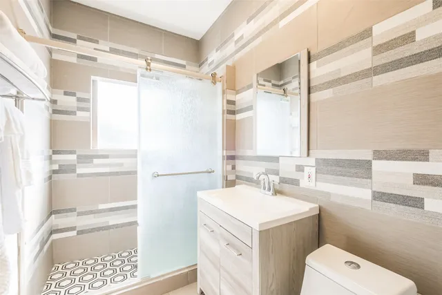 a bathroom with a sink a toilet and a shower