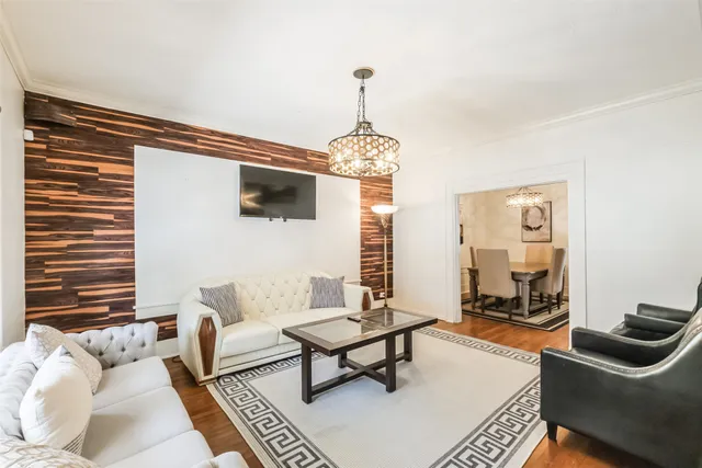 a living room with furniture a rug and a window