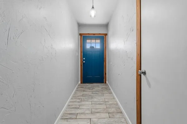 a view of a hallway with wooden floor