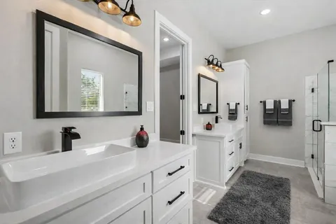 a bathroom with a sink a mirror a bathtub and shower