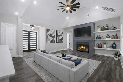 a living room with furniture and a fireplace