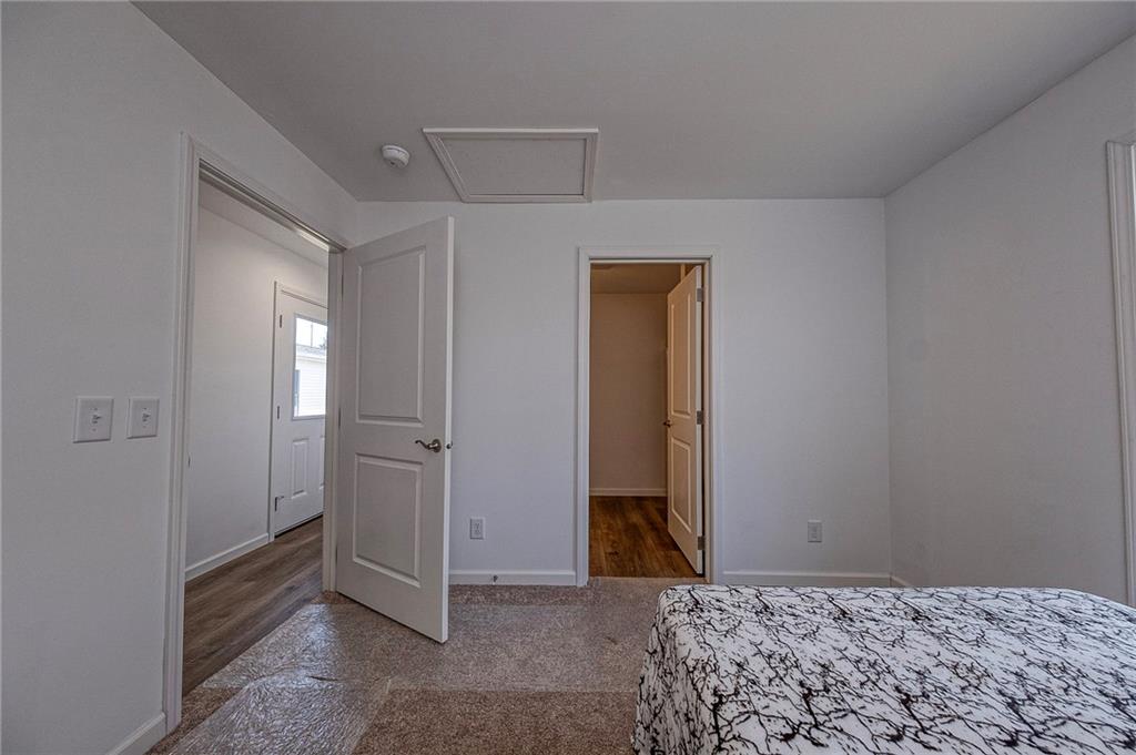 448 Motheral Avenue Monessen, PA 15062 - Photo 18 of 20 a bedroom with a bed and a hallway