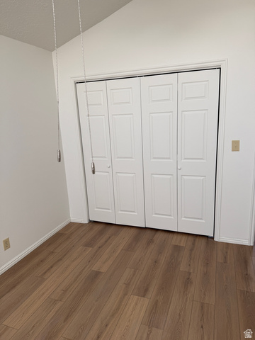 747 Hanover Drive Orem, UT 84058 - Photo 10 of 30 Unfurnished bedroom featuring a closet, dark wood-style flooring, and vaulted ceiling