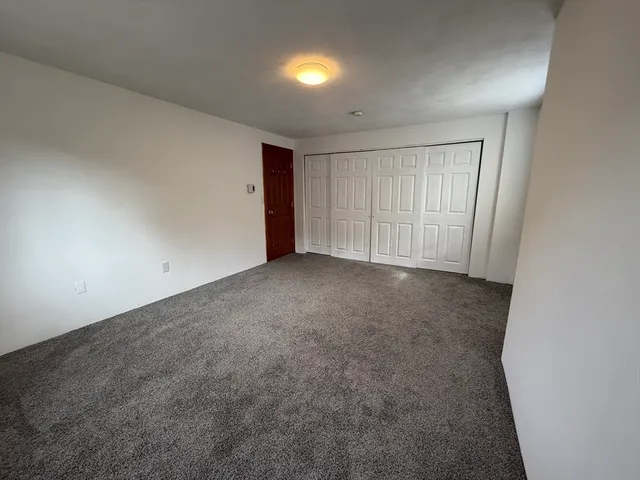 an empty room with closet area