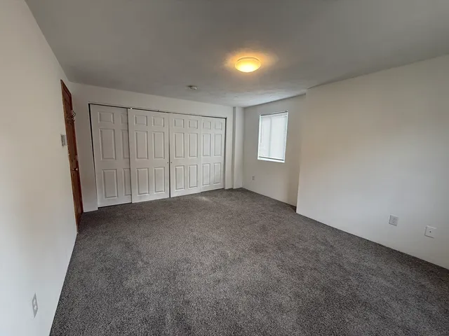 an empty room with a empty space and windows