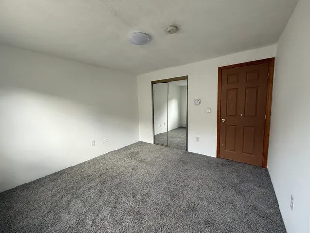 an empty room with closet area