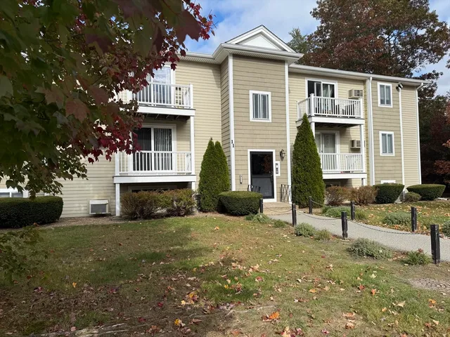 a view of a house with a yard and sitting area