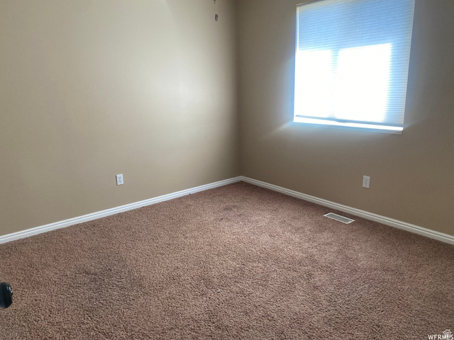 83 Canterbury Circle Logan, UT 84321 - Photo 8 of 23 Spare room with carpet and baseboards