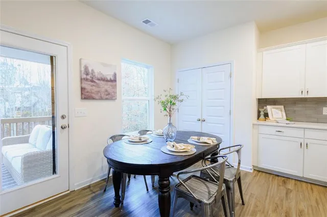 a view of a dining room with furniture and wooden floor