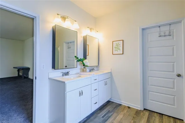 a spacious bathroom with a double vanity sink and a mirror