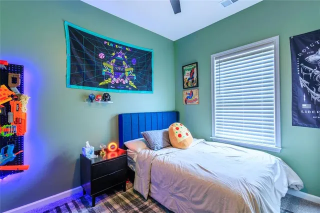 a bedroom with a bed and a window