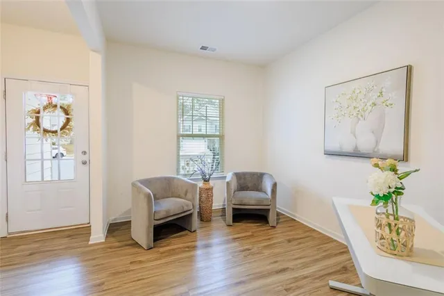 a living room with furniture and wooden floor