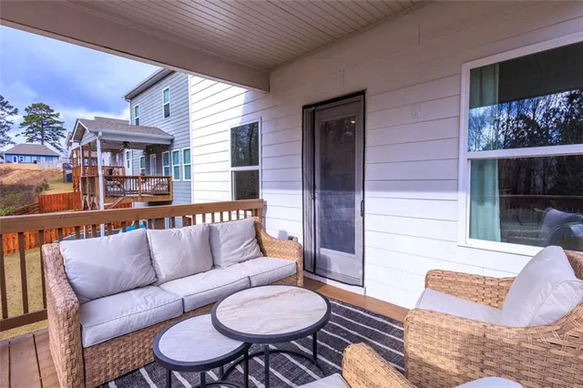 a living room with furniture a rug and a wall painting