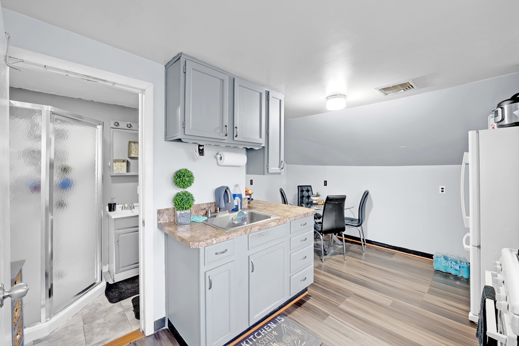 54 Airport Road Fitchburg, MA 01420 - Photo 13 of 38 a view of kitchen with refrigerator stove and wooden floor