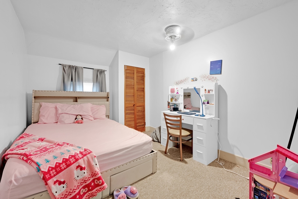 54 Airport Road Fitchburg, MA 01420 - Photo 18 of 38 a bedroom with a bed and a desk