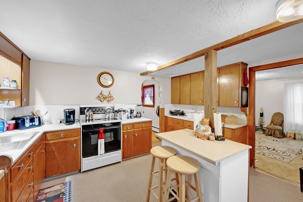 54 Airport Road Fitchburg, MA 01420 - Photo 2 of 38 a kitchen with stainless steel appliances granite countertop a sink stove and cabinets