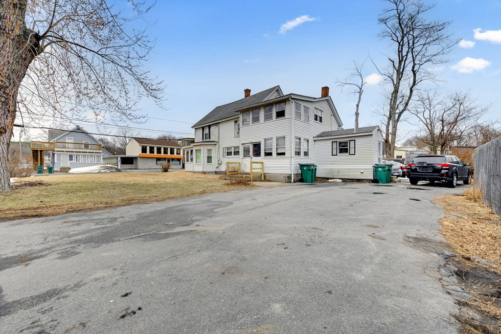 54 Airport Road Fitchburg, MA 01420 - Photo 21 of 38 a white house with a large tree in front of it