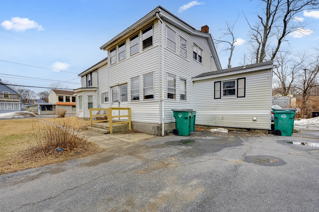 54 Airport Road Fitchburg, MA 01420 - Photo 22 of 38 a large white house with a large space in front of it