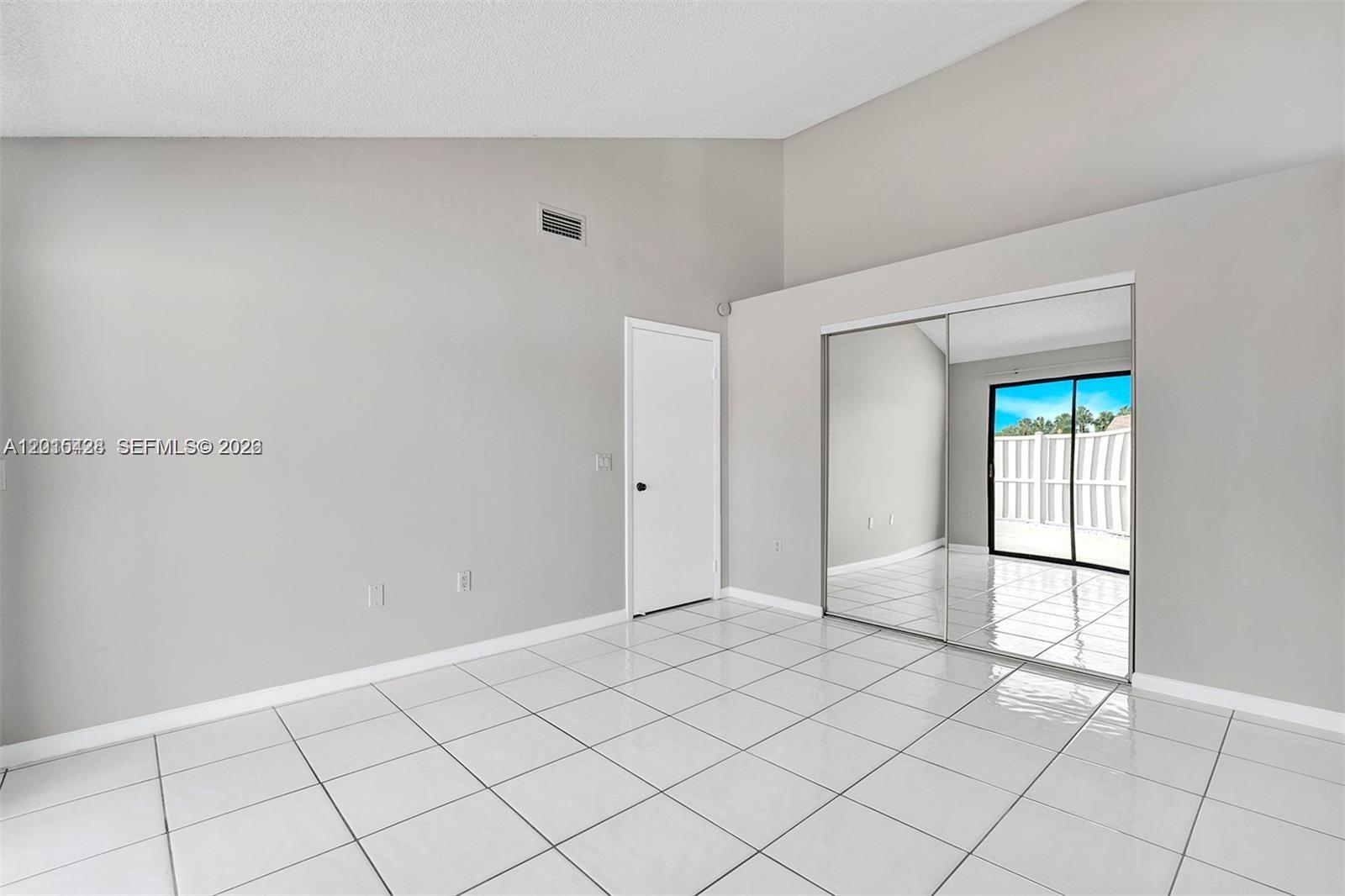 9892 Boca Gardens Parkway, Unit A Boca Raton, FL 33496 - Photo 20 of 32 a view of an empty room and window