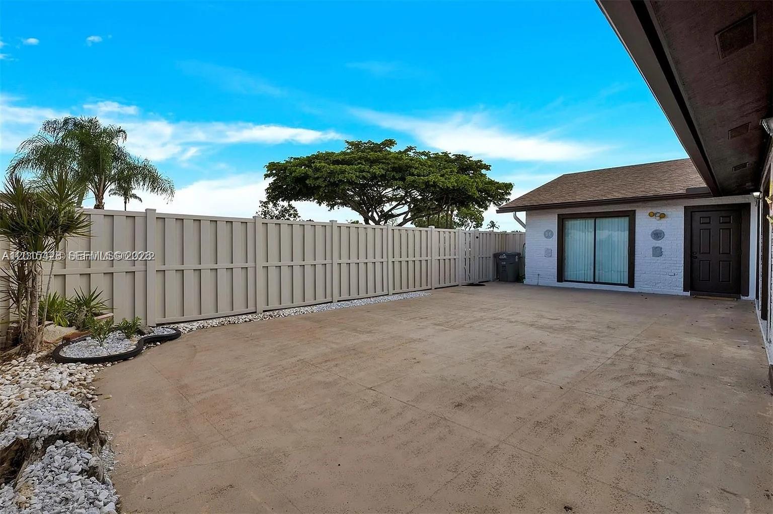 9892 Boca Gardens Parkway, Unit A Boca Raton, FL 33496 - Photo 2 of 32 a view of a house with a yard and potted plants