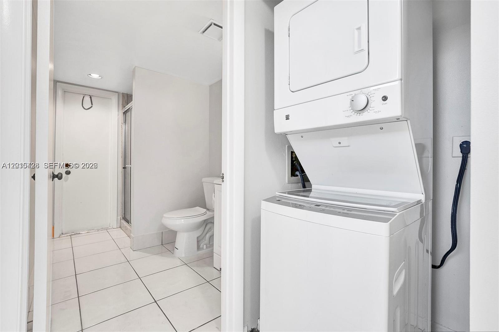 9892 Boca Gardens Parkway, Unit A Boca Raton, FL 33496 - Photo 21 of 32 a living room with a washer and dryer