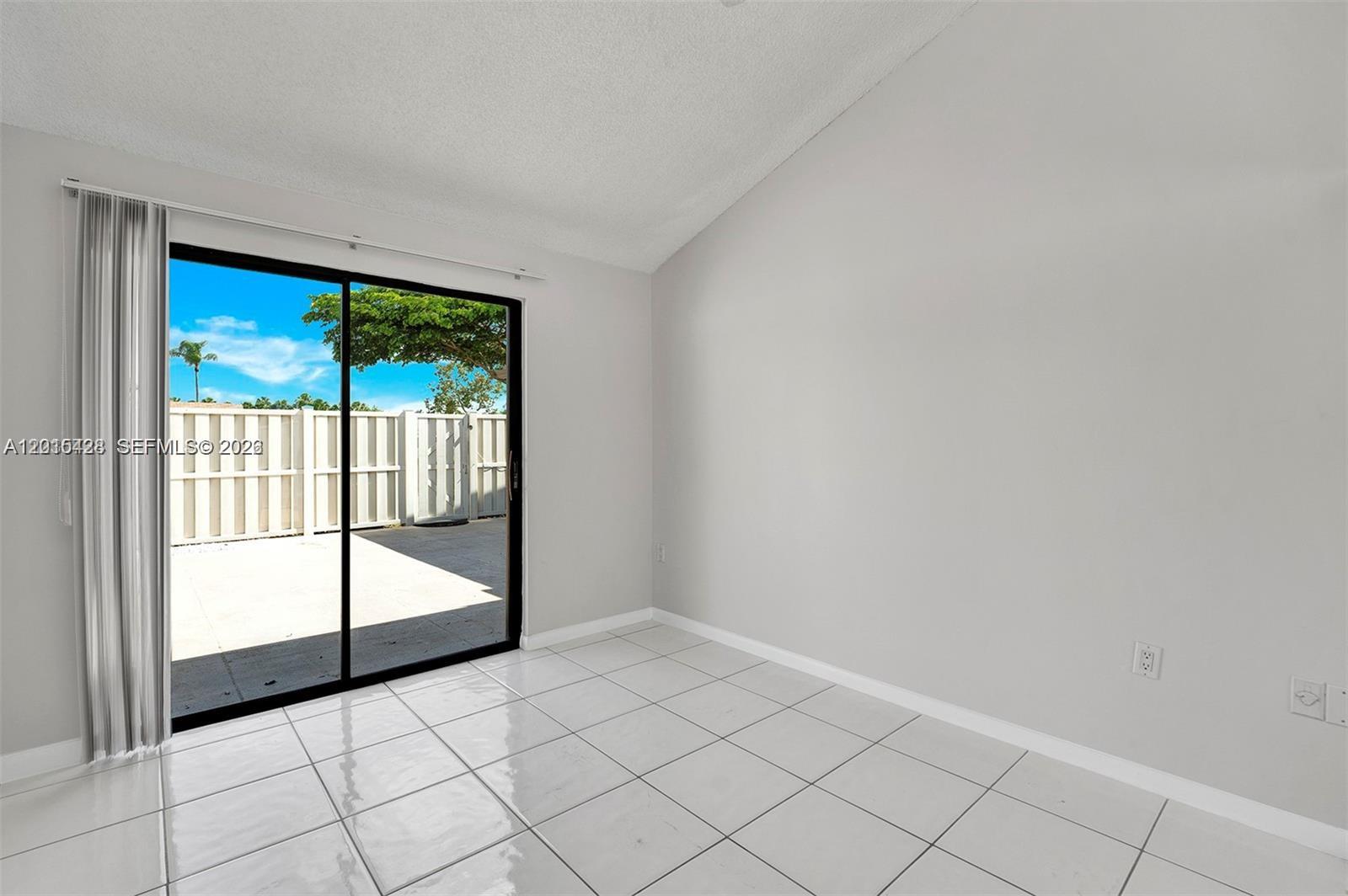 9892 Boca Gardens Parkway, Unit A Boca Raton, FL 33496 - Photo 23 of 32 a view of an empty room and window