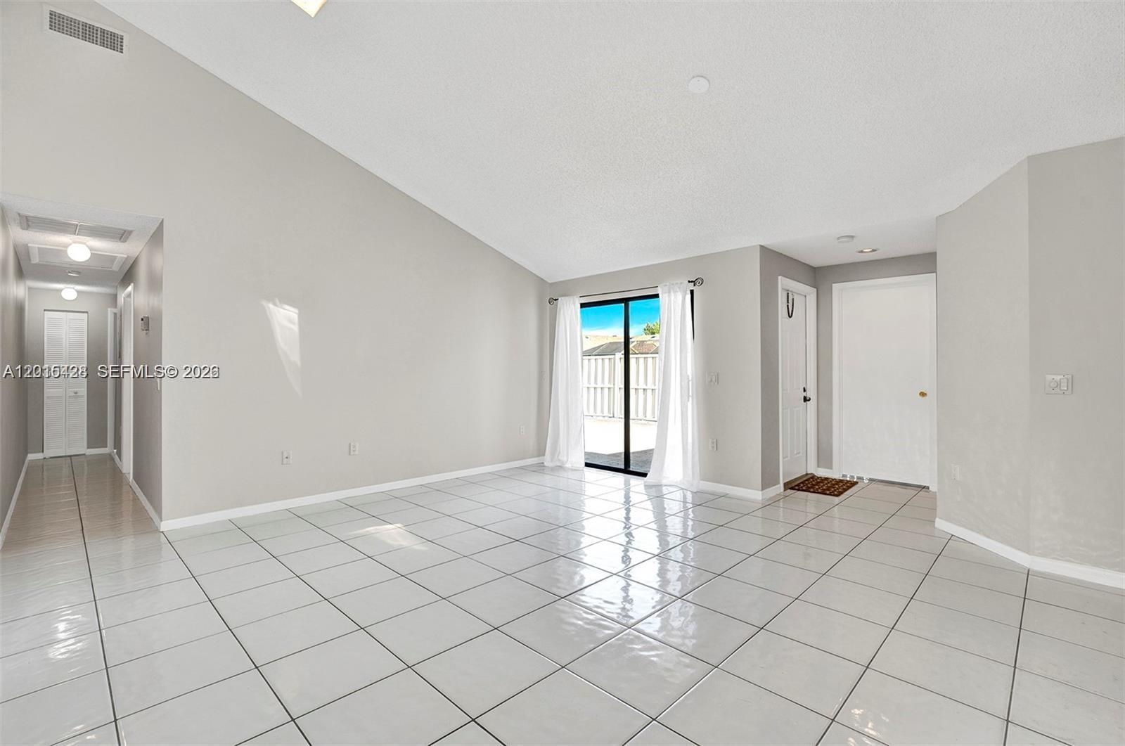9892 Boca Gardens Parkway, Unit A Boca Raton, FL 33496 - Photo 5 of 32 a view of an empty room and window in a room