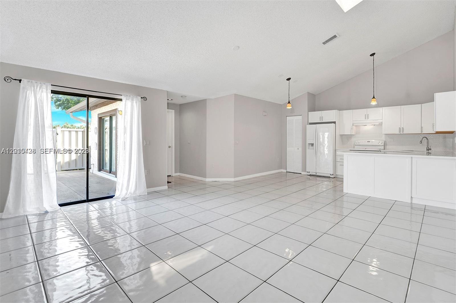 9892 Boca Gardens Parkway, Unit A Boca Raton, FL 33496 - Photo 6 of 32 a view of a kitchen with furniture and a kitchen